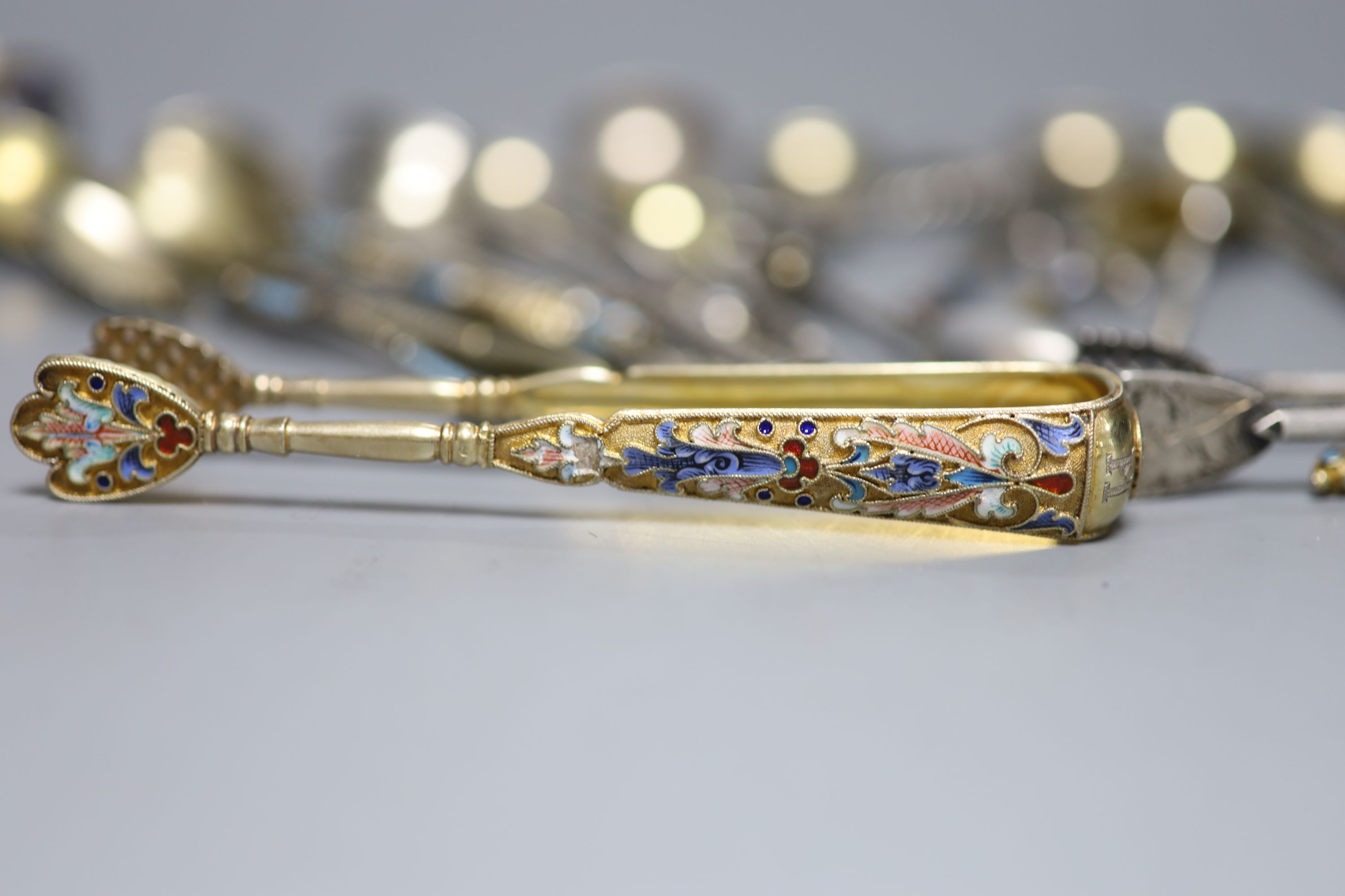 A small collection of Russian and Russian style white metal spoons etc, some with enamel or niello decoration.